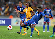 SuperSport United defender Morgan Gould (in blue) clears  the ball from  Siphiwe Tshabalala of Kaizer Chiefs during the cup quarterfinals in Durban yesterdayPicture:  Gallo Images