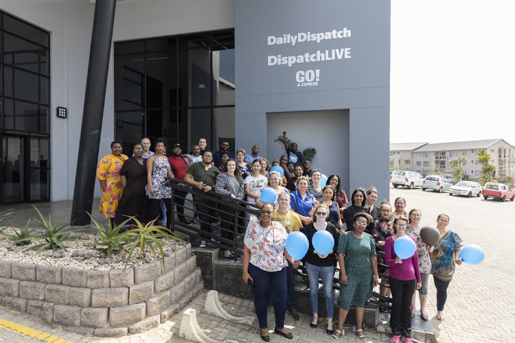 Some of the Daily Dispatch staff pose for a group photo ahead of the newspaper's 150th celebration.