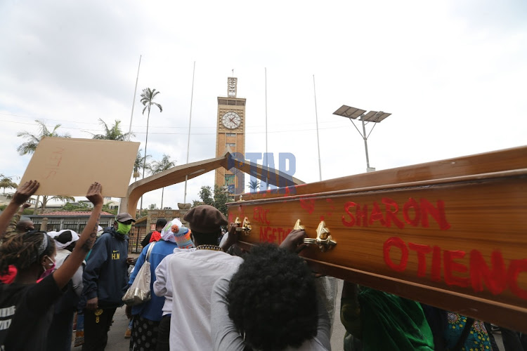 Youths carrying a coffin demonstrate outside Parliament on June 9, 2020.