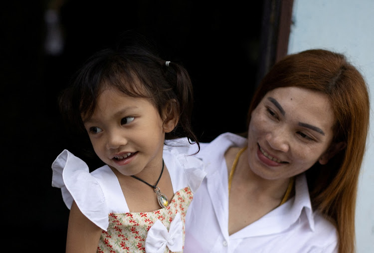 Panompai Sithong holds her 3-year-old daugther Paveenut Supolwong, nicknamed Ammy, during a family meeting at their home in Uthai Sawan, Nong Bua Lam Phu province, Thailand, October 9 2022. Picture JORGE SILVA/REUTERS