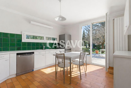 Cuisine avec table blanche et vue jardin dans cette Maison de luxe à vendre à Puyricard (740 000 € - 150 m²)