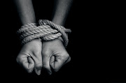 Human trafficking. Hands bound by rope. Image: STOCK PHOTO