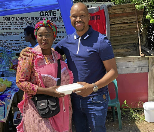 Snenhlanhla Shange serves another happy client her cow head delicacy from her stand in Sydenham, Durban. / SUPPLIED