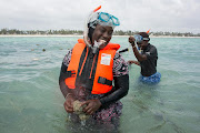 Nasir Hassan Haji smiles as she snorkels among her sponge farm in Jambiani, Zanzibar. 