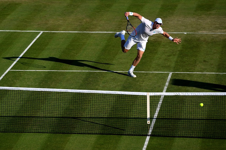 Kevin Anderson of South Africa plays a forehand in his Men's Singles second round match against Janko Tipsarevic of Serbia during Day three of The Championships - Wimbledon 2019 at All England Lawn Tennis and Croquet Club on July 03, 2019 in London, England.