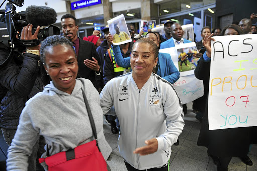 Banyana Banyana coach Desiree Ellis and players arrive at OR Tambo International Airport.