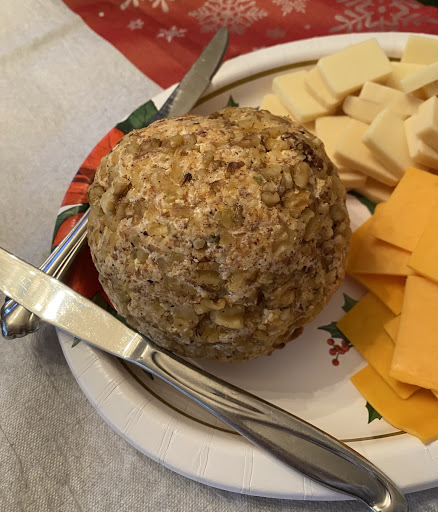 Cream cheese/sharp cheddar cheese ball rolled in  crushed walnuts. 