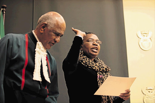 Constitutional Court Justice Zak Yacoob swears in Dina Pule as the new Minister of Communications at Tuynhuys yesterday Picture: SHELLEY CHRISTIANS