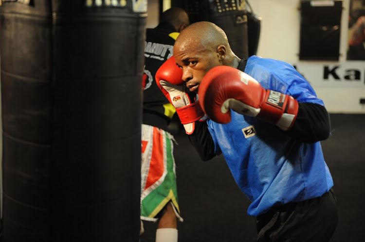 IBF flyweight world boxing champion Moruti "Babyface" Mthalane works on the heavy punching bag