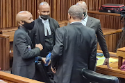 Ntuthuko Shoba speaks with his lawyers at the Johannesburg high court on Monday after the first day of his appearance for the murder of girlfriend Tshegofatso Pule in 2020.