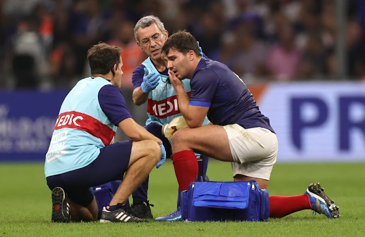 Antoine Dupont, the France captain, receives treatment after head contact with Johan Deysel during the Rugby World Cup France 2023 pool A match against Namibia at Stade Velodrome on September 21 2023 in Marseille, France.