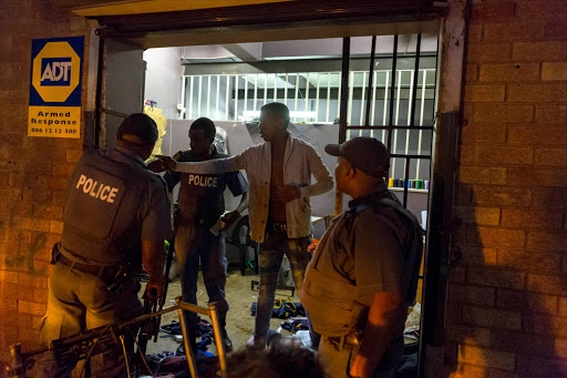 A man details incidents of looting and violence to police in Jeppestown.