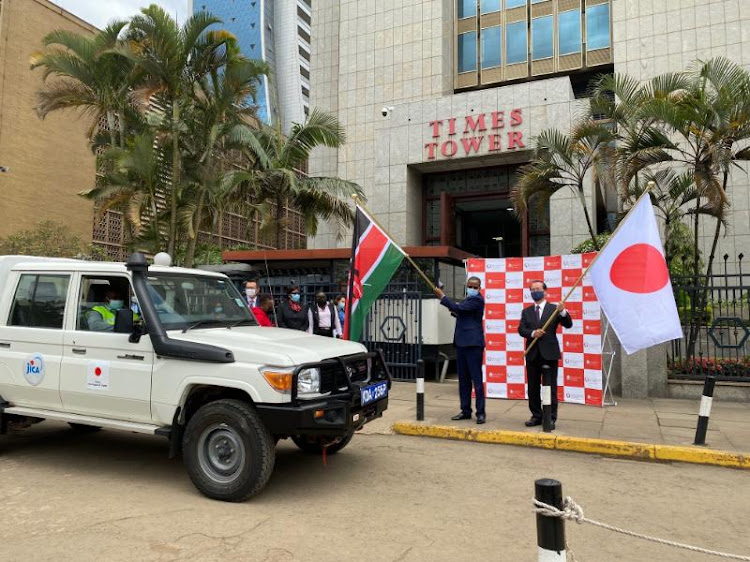 KRA Commissioner for Corporate Support Services David Kinuu and Japan Ambassador to Kenya Horie Ryoichi flag off a vehicle donated to the taxman on Thursday ar Time Towers, Nairobi