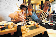 PLAYING CHOPSTICKS: Sophia Farber-Daniel, Maya Rabinowitz and Naomi Farber-Daniel try Nobu's seafood platter