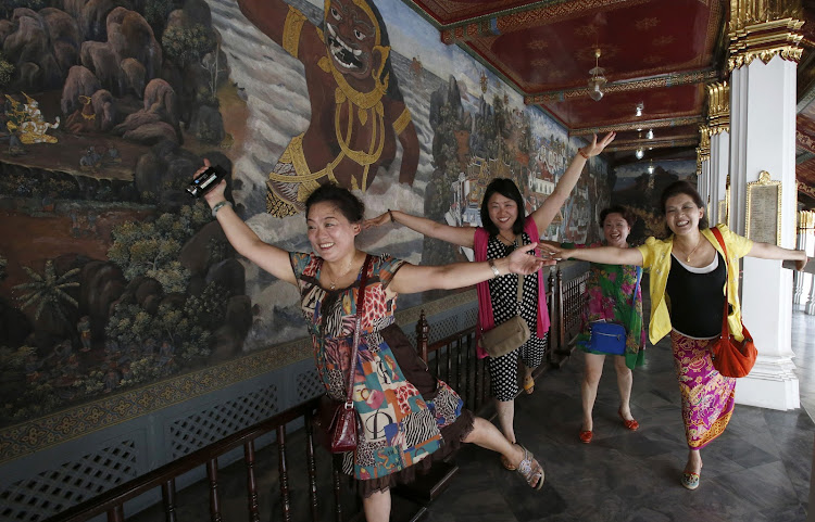 Chinese tourists at the Grand Palace in Bangkok. Destinations and brands are eager for their tourism spending after years of isolation, but they will have to make them feel welcome. Picture: ERIK DE CASTRO/REUTERS