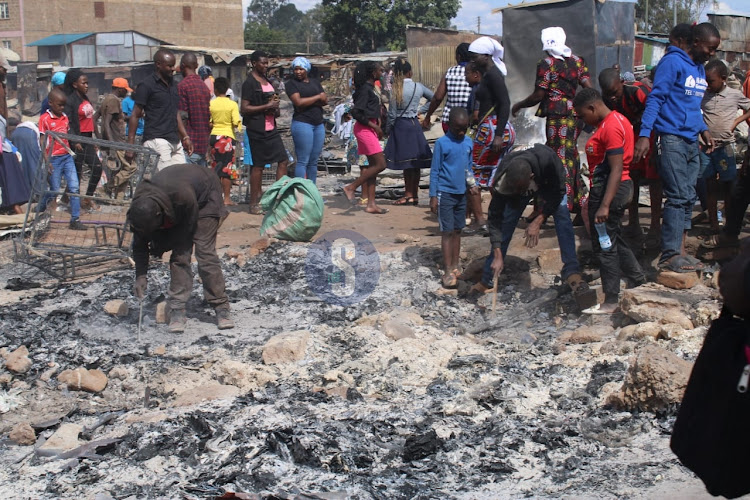 Traders at Toi market after their stalls were destroyed by fire on June 11,2023.