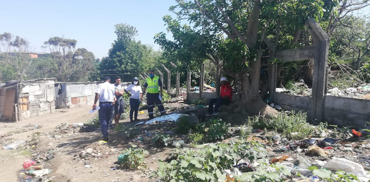 Police and community members next to the tree where Yonela Ntantiso was electrocuted.