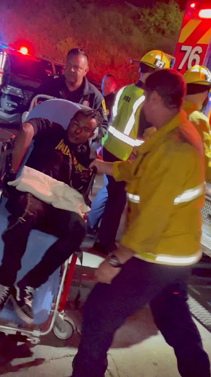 A man is transported into an ambulance after comedian Dave Chappelle was attacked on stage during stand-up Netflix show at the Hollywood Bowl, in Los Angeles, US on May 3, 2022, in this still image obtained from a social media video.