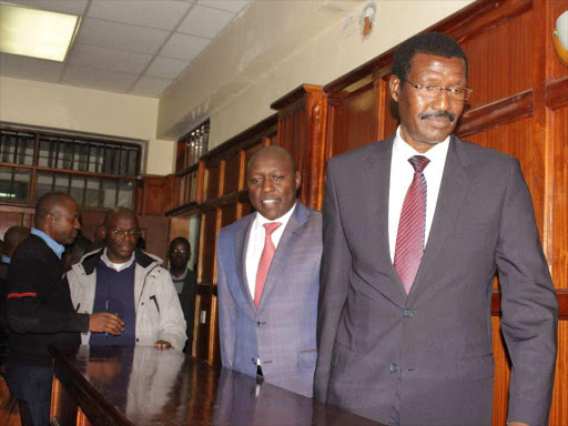 Former KPLC Managing Director and CEO Ben Chumo (right) and the current CEO Ken Tarus arrive at a Milimani court on Monday,July 16 where with others were charged with abuse of office.PHOTO/COLLINS KWEYU