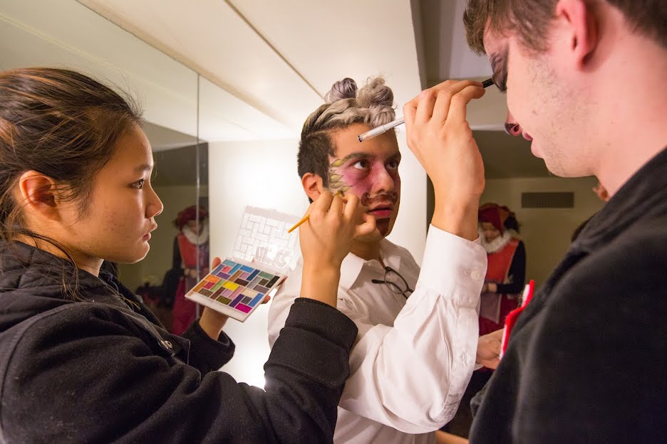 Students apply each other’s stage makeup for a theatrical production