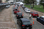Vehicles queue while medical personnel administer tests for the coronavirus disease (Covid-19) at the Bondi Beach drive-through testing centre as the city experiences an outbreak in Sydney, Australia, December 21, 2020. 