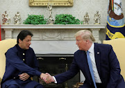 US President Donald Trump greets Pakistan's Prime Minister Imran Khan in the Oval Office at the White House in Washington, US, on July 22 2019. 
