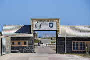 A  Welcome to Robben Island  sign at the harbour on the island.
