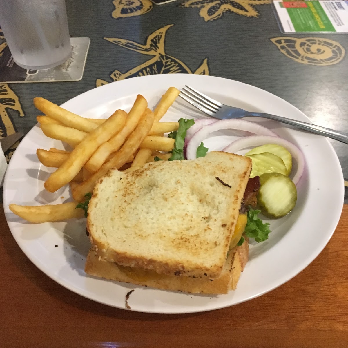 Bacon cheeseburger on gluten free bread with fries from a dedicated fryer.