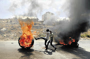 ROLLING ACTION: Palestinians protest in Gaza in a clash that the author thinks is really about the future of Islam.