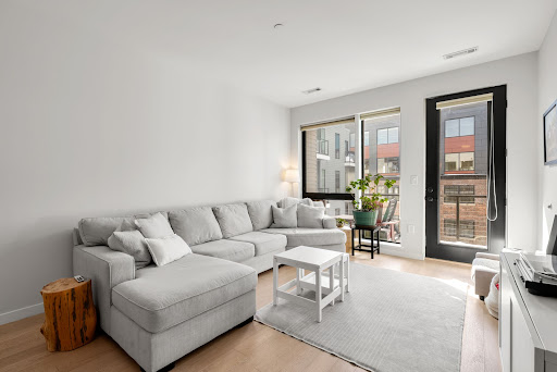 Buy this luxury property in Boston (United States) - Modern living room with large gray sectional sofa