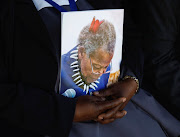 A woman holds a document at the category one state funeral of traditional prime minister to the Zulu king Mangosuthu Buthelezi.