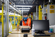 An employee works at Amazon's JFK8 distribution center in Staten Island, New York, US.