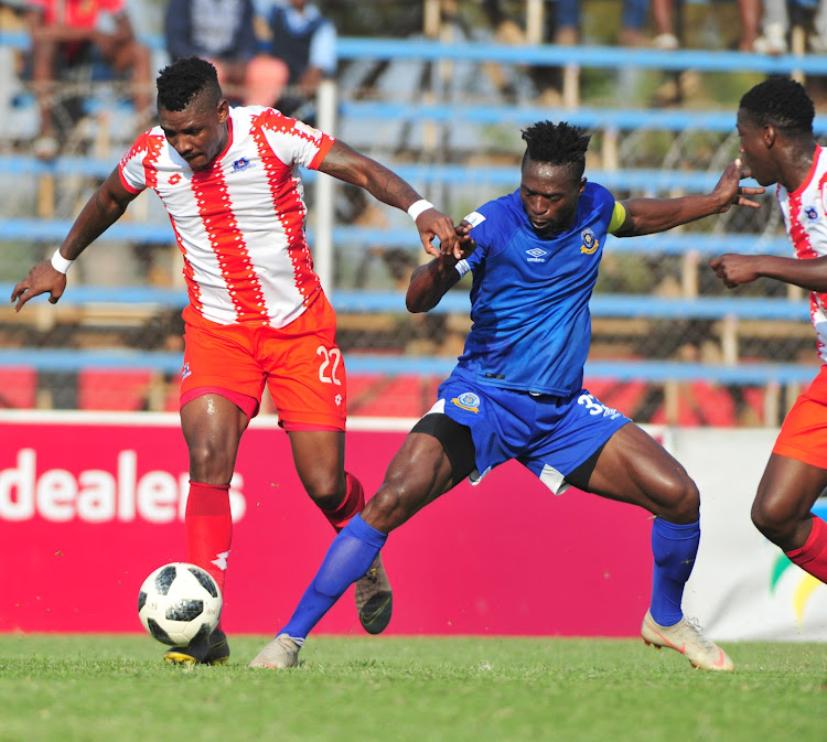 Mohau Mokate (L) of Maritzburg United and Carlington Nyadombo (R) of Tshakhuma Tsha Madzivhandila tussle for the ball during the National First Division Playoffs match at Thohoyandou Stadium on May 22 2019.