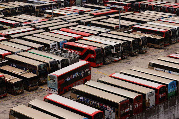 Kowloon Motor Bus (KMB) double-decker buses are seen parked at a bus depot, after services were cut as coronavirus disease (Covid-19) cases surge in Hong Kong, China, March 3, 2022.