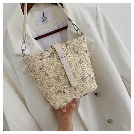 Title 16, Straw bucket bag with lace embroidery. A stylis...
