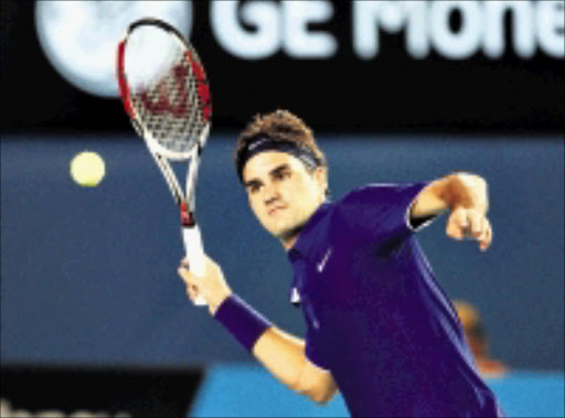 SWISS MASTER: Roger Federer hits a ball into the crowd after beating Juan Martin del Potro in the men's singles quarterfinal match at the Australian Open in Melbourne yesterday.27/01/09. Pic. Rick Stevens. © AP.