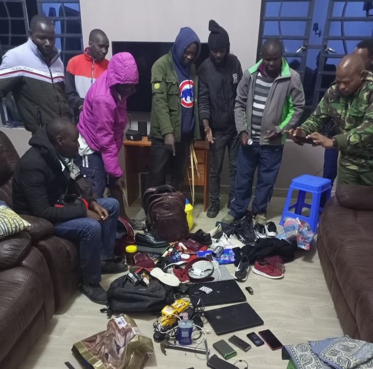 Police and members of the public look at the recovered stolen items after a botched robbery at a woman's house in Koma, within Matungulu, Machakos County on Sunday, September 4, 2022.