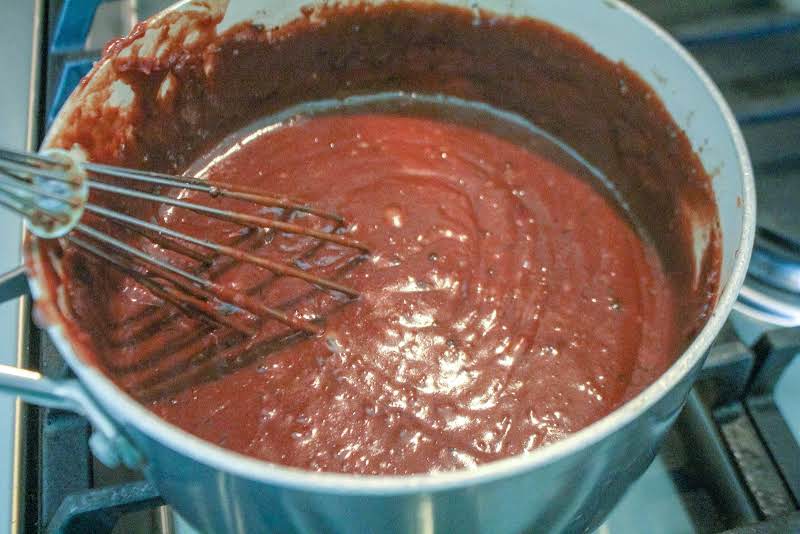 Chocolate Pudding Ingredients Thickening In A Saucepan.