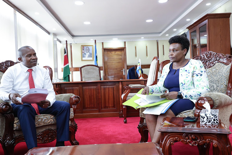 Interior CS Kithure Kindiki consults with Director General of Immigration and Citizen Services Evelyn Cheluget on April 30, 2024.