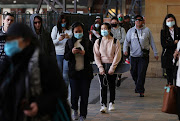 Commuters walk at Central Station, as the state of New South Wales experiences a decrease in new cases of the coronavirus disease (COVID-19), in Sydney, Australia, August 11, 2020. 