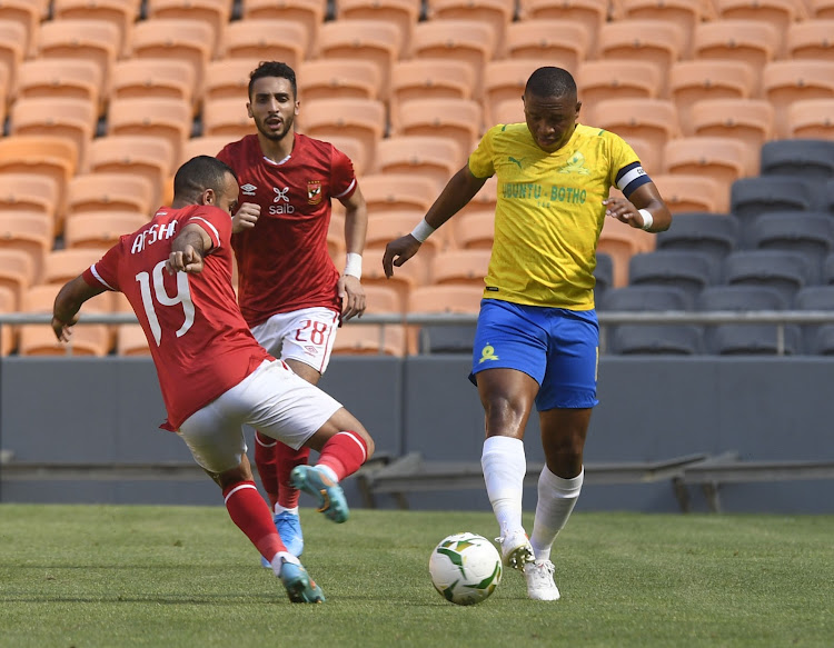 Andile Jali of Mamelodi Sundowns challenged by Mohamed Mousry of Al Ahly SC during their CAF Champions League FNB Stadium.