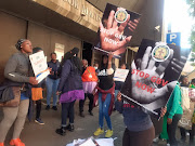 Protesters outside the Pretoria magistrate’s court on Tuesday, where Kenneth Debeila made his second appearance on charges of murder, rape and robbery with aggravating circumstances.