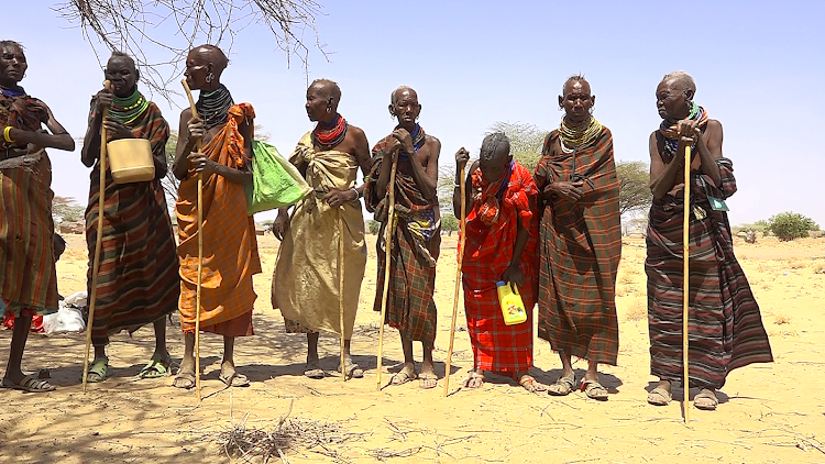 Drought victims wait for relief food rations in Turkana