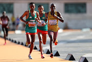 Tamirat Tola of Team Ethiopia and Victor Kiplangat of Team Uganda compete in the men's marathon on day nine of the World Athletics Championships in Budapest, Hungary on Sunday.