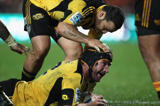 Andrew Hore of the Hurricanes is congratulated by Piri Weepu after scoring a try during the Super Rugby match between the Chiefs and the Hurricanes at Waikato Stadium on June 10, 2011 in Hamilton, New Zealand