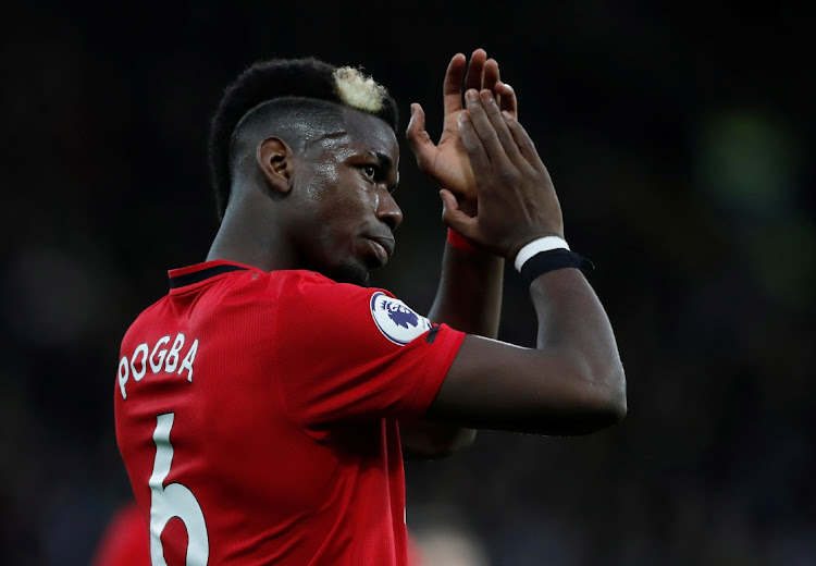 Manchester United’s Paul Pogba applauds fans after the EPL loss against Watford at Vicarage Road