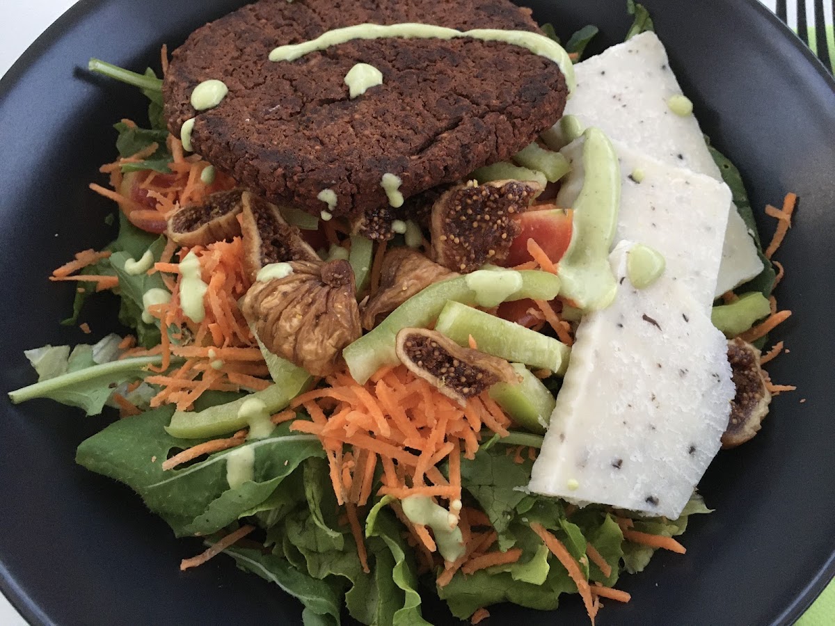 Garden Salad with add ons: Vegan Parmesan Cheese with Truffle, Beetroot Patty; bowl with carrots, dried figs, greens, paprika