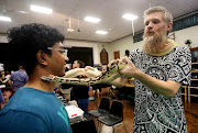 Trilochan Naidoo admires a vesta fire pastel displayed by Gareth Sykes from Aquartica which is selling for R2000 at a Reptile Expo by Northcoast Contractors in Pinetown. The reptile expo is back with a bang after 6 years of drought in KwaZulu-Natal. Some snakes like the VPI axanthic clown were selling for R35000. 