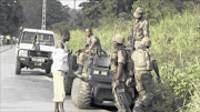  Armed South African soldiers chat with a man near Begoua, 17 km from  the capital Bangui.
  