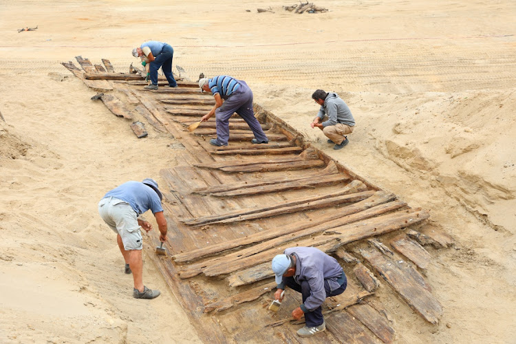 Archaeologists excavate the hull of a wooden ship, an ancient Roman flat-hulled riverine vessel at the ancient city of Viminacium, near Kostolac, Serbia, August 2, 2023.